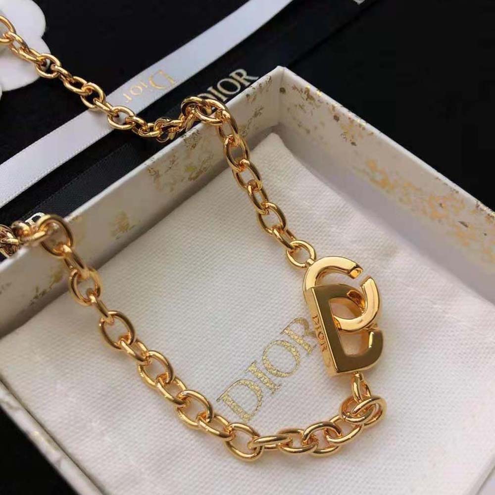 Gold dior lock necklace best sale